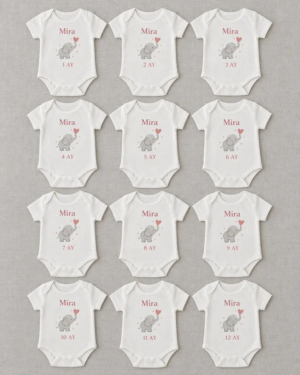 Twelve white bodysuits with grey elephant illustrations, pink month wording from 1 to 12 and the name Mira
