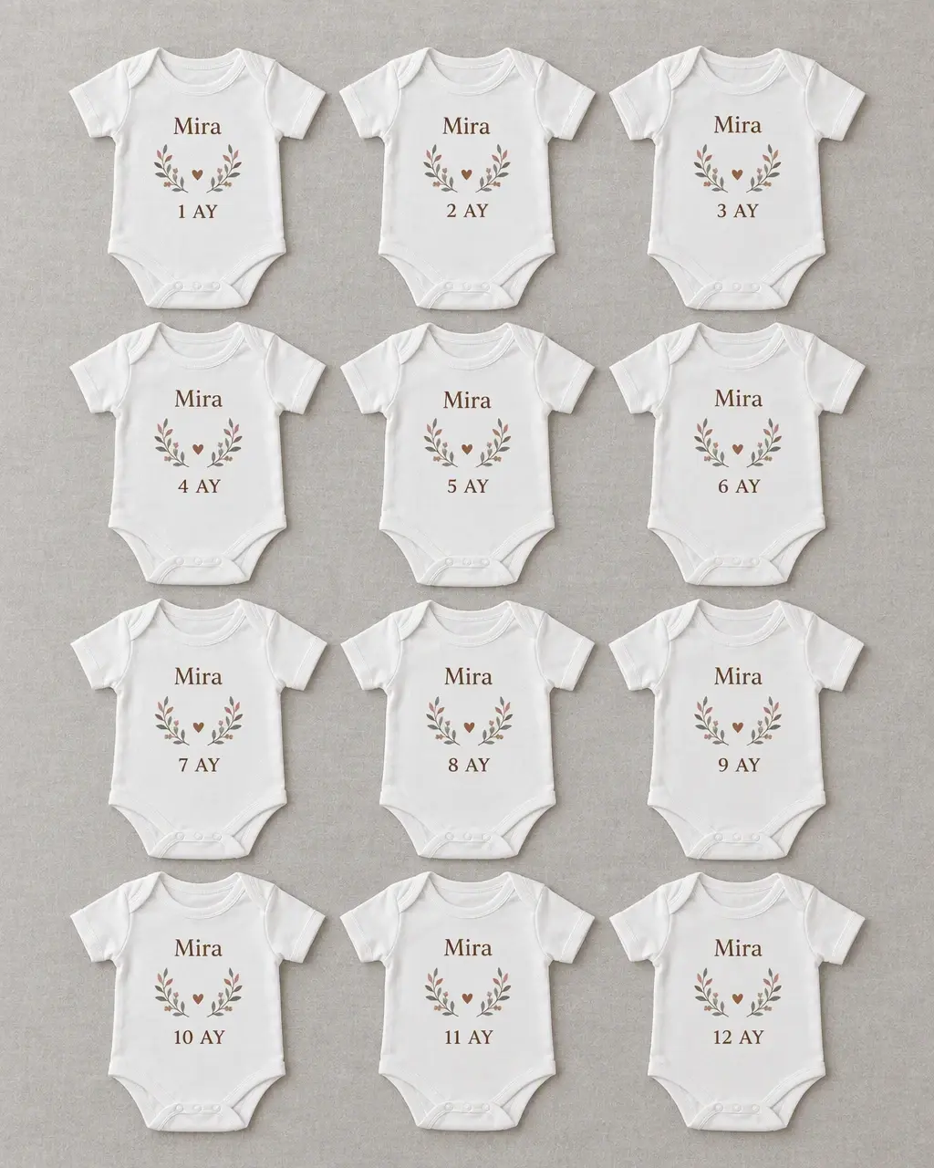 Twelve white bodysuits with warm-neutral numbers from 1 to 12 and the name Mira