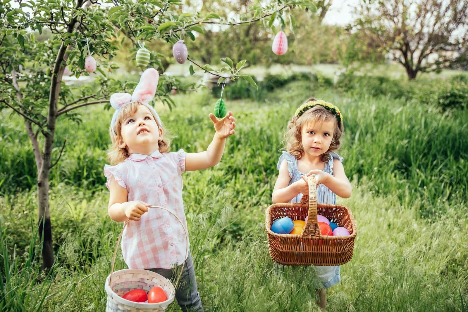 Group Of Children Wearing Bunny Ears Running To Pick Up colorful Egg On Easter Egg Hunt In Garden