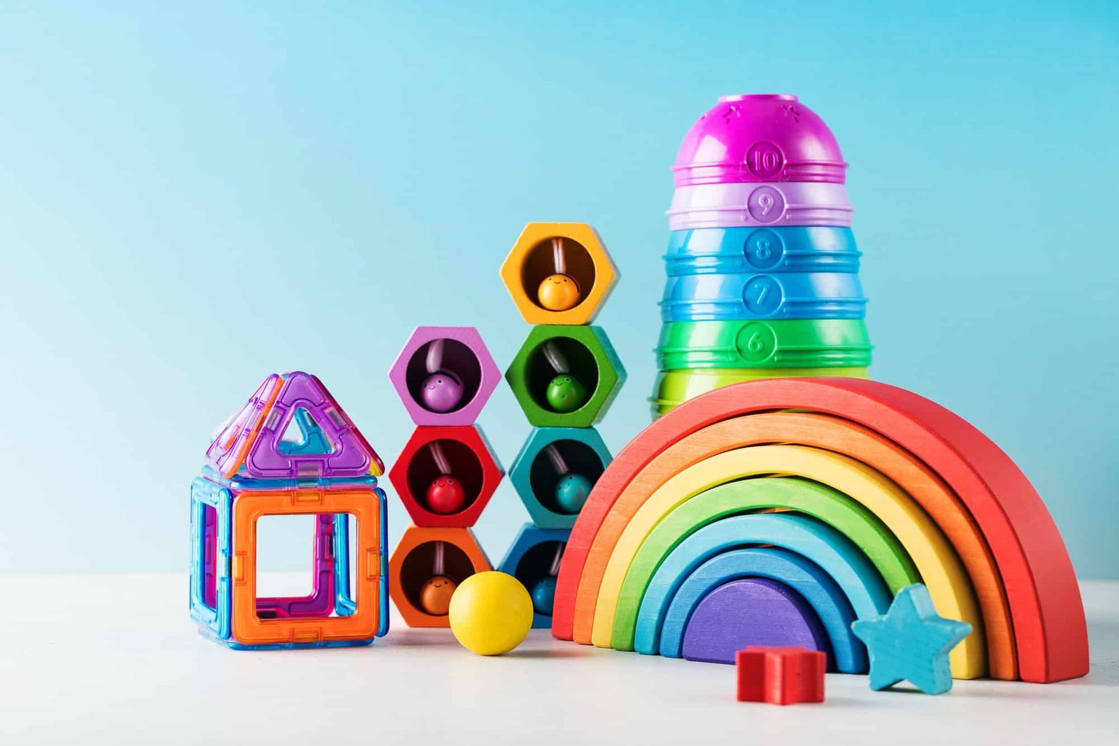 Contemporary Toys To Play And Develop For Toddlers On Blue Background Closeup